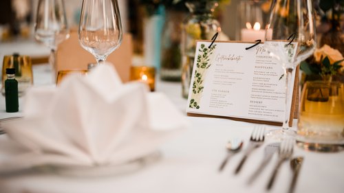 Restaurant Gronau: Seeblick Elegant set table with glasses, napkin, and menu card at event